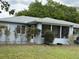 Back of the home featuring a nice screened in back porch and updated paint color at 6082 Sw 104Th St, Ocala, FL 34476