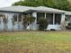 Exterior view of the home showcasing the screened porch and well-maintained landscaping at 6082 Sw 104Th St, Ocala, FL 34476