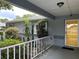 Inviting front porch with a charming yellow door and lush landscaping at 6082 Sw 104Th St, Ocala, FL 34476