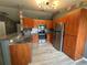 Bright kitchen featuring stainless steel appliances, wooden cabinets, and granite countertops at 6082 Sw 104Th St, Ocala, FL 34476