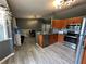 Open-concept kitchen with stainless steel appliances, bar seating, and adjacent dining area at 6082 Sw 104Th St, Ocala, FL 34476