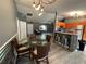 The expansive living area features modern flooring, an open floor plan, and a glass table in the dining area at 6082 Sw 104Th St, Ocala, FL 34476