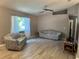 Bright living room featuring updated flooring, a ceiling fan, and natural light from a window at 6082 Sw 104Th St, Ocala, FL 34476
