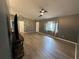 Inviting living room boasts luxury vinyl flooring, textured wallpaper, and a modern ceiling fan at 6082 Sw 104Th St, Ocala, FL 34476
