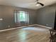 Bright living room featuring gray walls, luxury vinyl flooring, and a modern ceiling fan at 6082 Sw 104Th St, Ocala, FL 34476