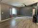 Spacious living room featuring gray walls, luxury vinyl flooring, and a modern ceiling fan at 6082 Sw 104Th St, Ocala, FL 34476