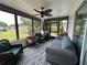 Inviting sunroom features neutral colors, a ceiling fan, and a wall of windows to let in natural light at 6082 Sw 104Th St, Ocala, FL 34476