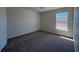 Empty bedroom with grey carpet and one window at 6134 Sw 155Th Street Road, Ocala, FL 34473