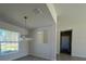 Bright dining room with modern chandelier and large window offering ample natural light at 6134 Sw 155Th Street Road, Ocala, FL 34473