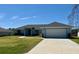 Charming single-story home with a well-maintained lawn and a spacious driveway at 6134 Sw 155Th Street Road, Ocala, FL 34473