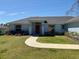 Inviting home exterior with green lawn and walkway leading to the red front door at 6134 Sw 155Th Street Road, Ocala, FL 34473
