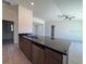 Open kitchen featuring dark countertops, a stainless steel sink, and an eat-in breakfast bar at 6134 Sw 155Th Street Road, Ocala, FL 34473