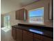 Modern kitchen featuring dark countertops, ample cabinet space, and a window for natural light at 6134 Sw 155Th Street Road, Ocala, FL 34473