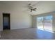 Bright living room with wood floors and a sliding door to the backyard at 6134 Sw 155Th Street Road, Ocala, FL 34473