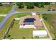 Aerial view of the home featuring a fenced yard, solar panels, and a storage shed at 6890 Sw 128Th Pl, Ocala, FL 34473