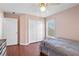 Bedroom featuring wood laminate floors, ceiling fan, closet, and a cozy bed at 6890 Sw 128Th Pl, Ocala, FL 34473