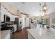 Bright, open kitchen with stainless steel appliances and a large island at 6890 Sw 128Th Pl, Ocala, FL 34473