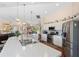Open kitchen featuring stainless steel appliances, white cabinetry, and eat-in dining area at 6890 Sw 128Th Pl, Ocala, FL 34473