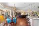 Open-concept living space flows to dining area, highlighted by laminate floors and a neutral color palette at 6890 Sw 128Th Pl, Ocala, FL 34473
