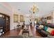 Elegant living room with hardwood floors, chandelier, and comfortable seating at 6890 Sw 128Th Pl, Ocala, FL 34473