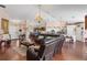 Spacious open-concept living area featuring lots of natural light and laminate wood floors at 6890 Sw 128Th Pl, Ocala, FL 34473