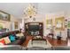 Comfortable living room with hardwood floors, chandelier, and sliding door access at 6890 Sw 128Th Pl, Ocala, FL 34473