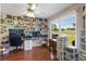 Cozy office space featuring a large window, laminate flooring, and built-in shelving at 6890 Sw 128Th Pl, Ocala, FL 34473