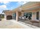 Covered patio with furniture, BBQ and ceiling fan with access to the fenced yard at 6890 Sw 128Th Pl, Ocala, FL 34473