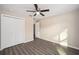 A spacious bedroom featuring wood-look floors, a ceiling fan, and double closets at 7798 Sw 134Th Ave, Dunnellon, FL 34432