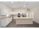 Modern kitchen with white cabinetry, stainless steel appliances, and granite island, complete with recessed lighting at 7798 Sw 134Th Ave, Dunnellon, FL 34432