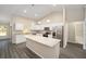 Well-equipped kitchen features white cabinets, stainless steel appliances, and a center island with granite countertop at 7798 Sw 134Th Ave, Dunnellon, FL 34432