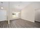 Bright living room with vaulted ceiling, wood-look floors, and natural light at 7798 Sw 134Th Ave, Dunnellon, FL 34432