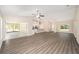 Spacious living room boasts vaulted ceilings, wood-look floors, and seamless access to kitchen and outdoor spaces at 7798 Sw 134Th Ave, Dunnellon, FL 34432