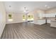Open-concept living room with access to the kitchen and outdoor living, complemented by wood-look floors at 7798 Sw 134Th Ave, Dunnellon, FL 34432
