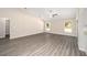 Spacious living room showcasing vaulted ceilings, wood-look floors, and large windows for ample natural light at 7798 Sw 134Th Ave, Dunnellon, FL 34432