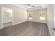 Main bedroom featuring a ceiling fan, wood-look flooring, and bright windows at 7798 Sw 134Th Ave, Dunnellon, FL 34432
