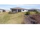 Spacious backyard featuring a well-maintained lawn and a covered patio, ideal for outdoor relaxation and entertainment at 8218 Sw 92Nd Cir, Ocala, FL 34481