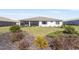 Lush backyard with a covered patio and well-manicured lawn, offering a serene outdoor space for leisure and gatherings at 8218 Sw 92Nd Cir, Ocala, FL 34481