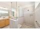 Bright bathroom features double vanity with wood cabinets and a walk-in shower at 8218 Sw 92Nd Cir, Ocala, FL 34481