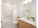 This bright bathroom offers a tub shower, tile flooring, and a wood vanity at 8218 Sw 92Nd Cir, Ocala, FL 34481