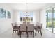 Bright dining room features neutral walls, light tile floors, and backyard views at 8218 Sw 92Nd Cir, Ocala, FL 34481