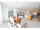 Dining area showcasing a table for six next to an open-concept kitchen and sliding glass doors at 8218 Sw 92Nd Cir, Ocala, FL 34481