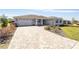 Single-story home with a brick paver driveway, two-car garage and well-maintained landscaping at 8218 Sw 92Nd Cir, Ocala, FL 34481