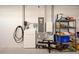 Organized garage featuring a Tesla power wall, shelving and space for storage, offering functionality and convenience at 8218 Sw 92Nd Cir, Ocala, FL 34481