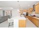 View of the kitchen featuring stainless steel appliances, quartz countertops, a large center island and seating at 8218 Sw 92Nd Cir, Ocala, FL 34481