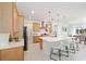 Kitchen featuring quartz countertops, a large island, and stainless steel appliances, with dining area view at 8218 Sw 92Nd Cir, Ocala, FL 34481