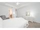 Bright main bedroom features neutral walls, carpet floors, and white furnishings at 8218 Sw 92Nd Cir, Ocala, FL 34481