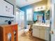 Well-lit bathroom with a shower, tiled floors, and decor at 9172 Se 130Th Loop, Summerfield, FL 34491