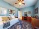 Inviting bedroom with a large patterned rug, golf decor and a bright, airy atmosphere at 9172 Se 130Th Loop, Summerfield, FL 34491