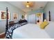 Well-lit bedroom featuring a four-poster bed with stylish black and white throw and decorative artwork at 9172 Se 130Th Loop, Summerfield, FL 34491
